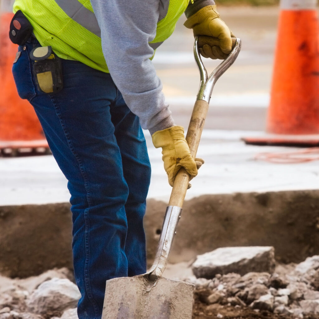 Worker digging road